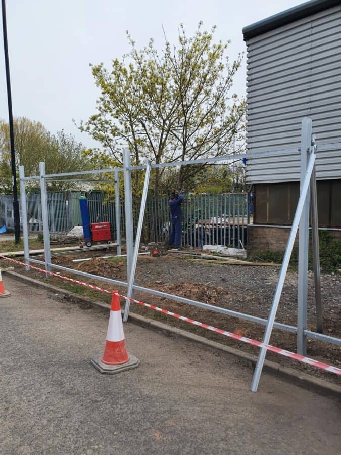 Commercial steel fencing installation in progress